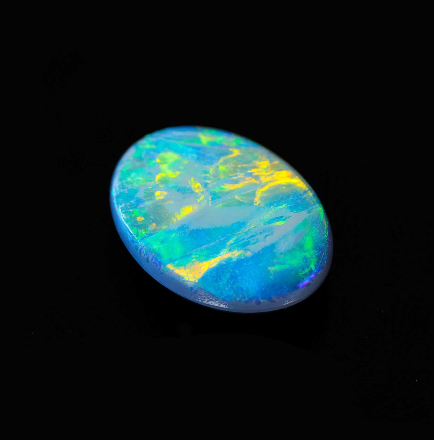 Oval semi-black opal from Lightning Ridge with vivid orange and green flashes