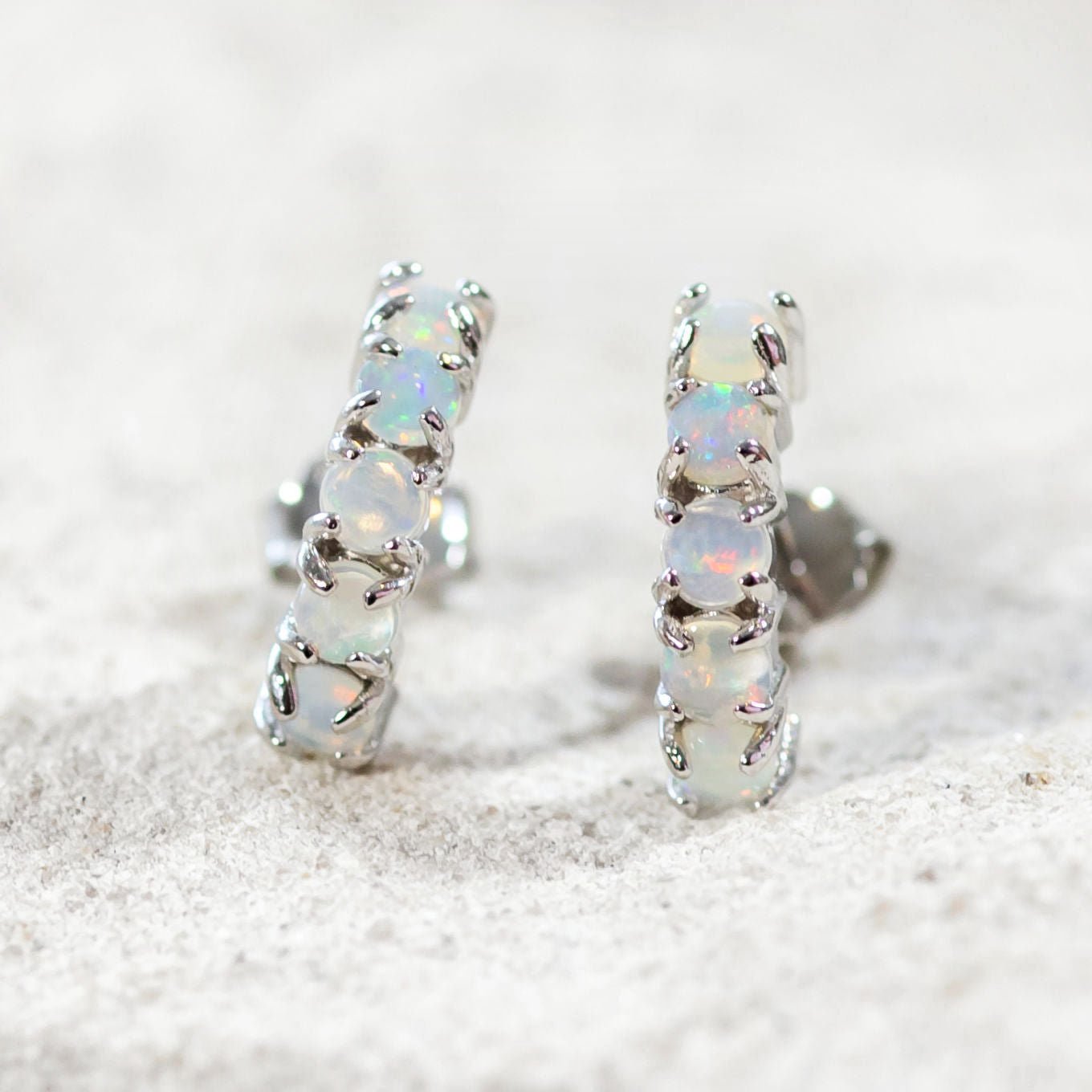 10 round opals set into sterling silver curved stud earrings