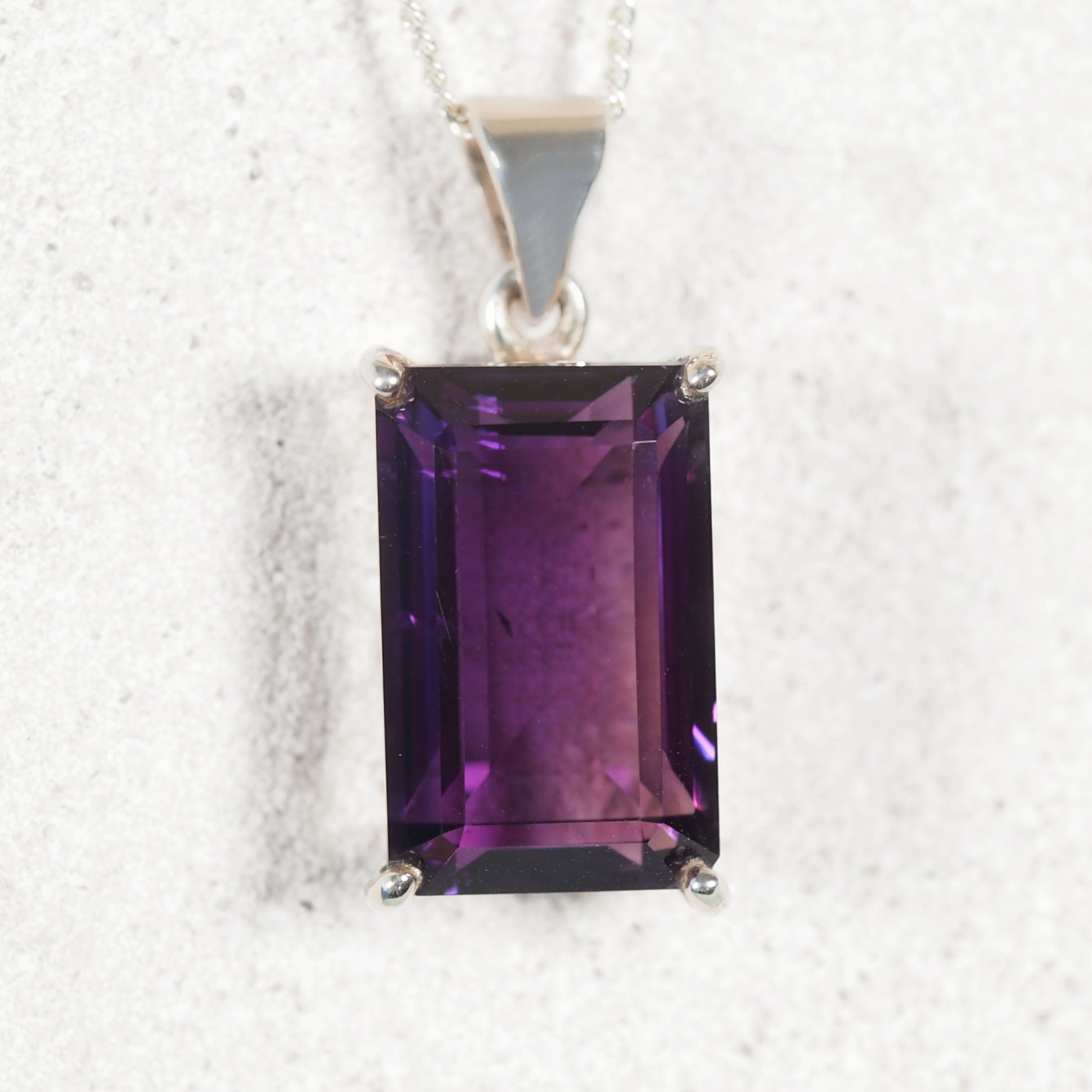 Amethyst pendant on a white background