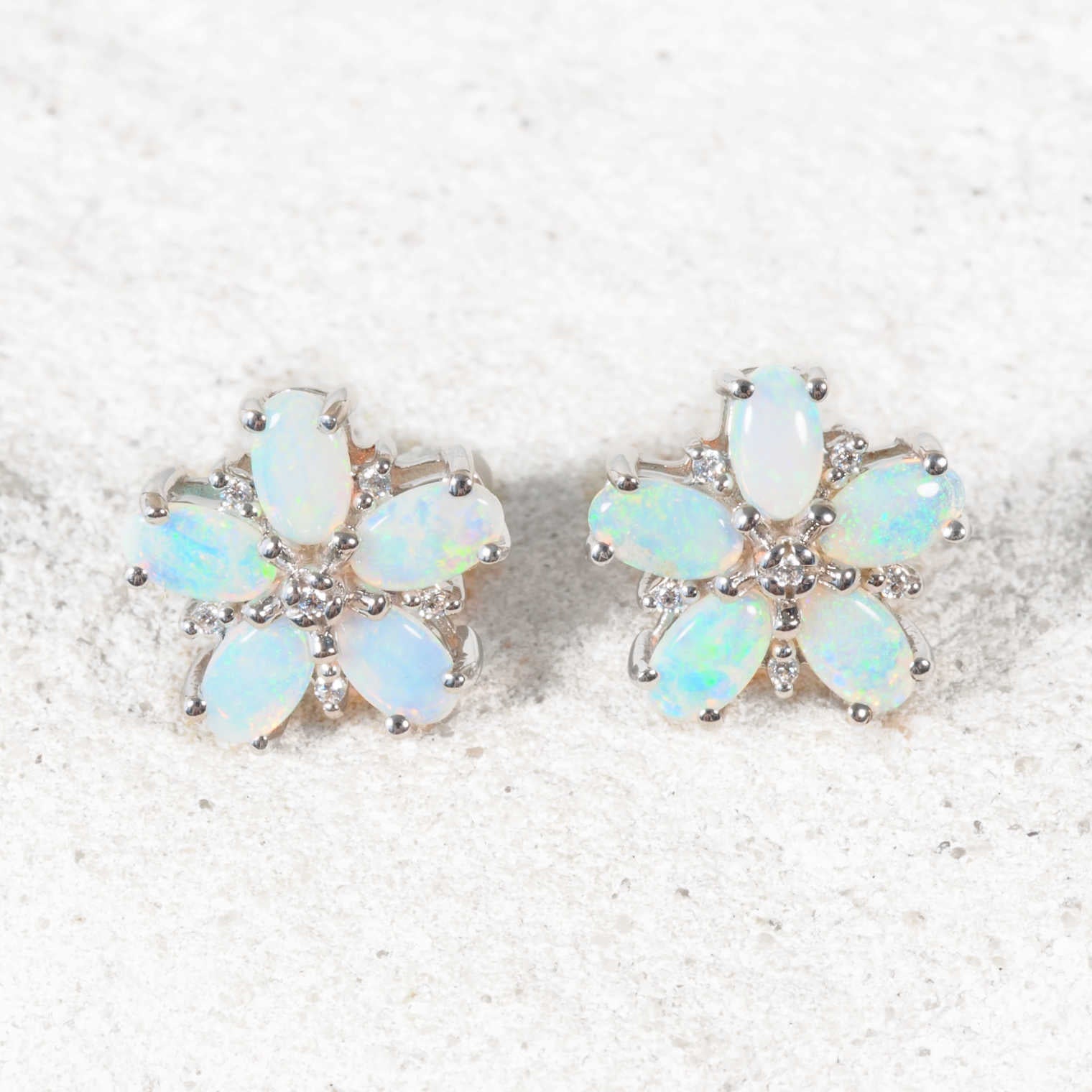 Close-up of 'Azalea Blue' opal earrings showing vivid blue and green opals and sparkling cubic zirconias