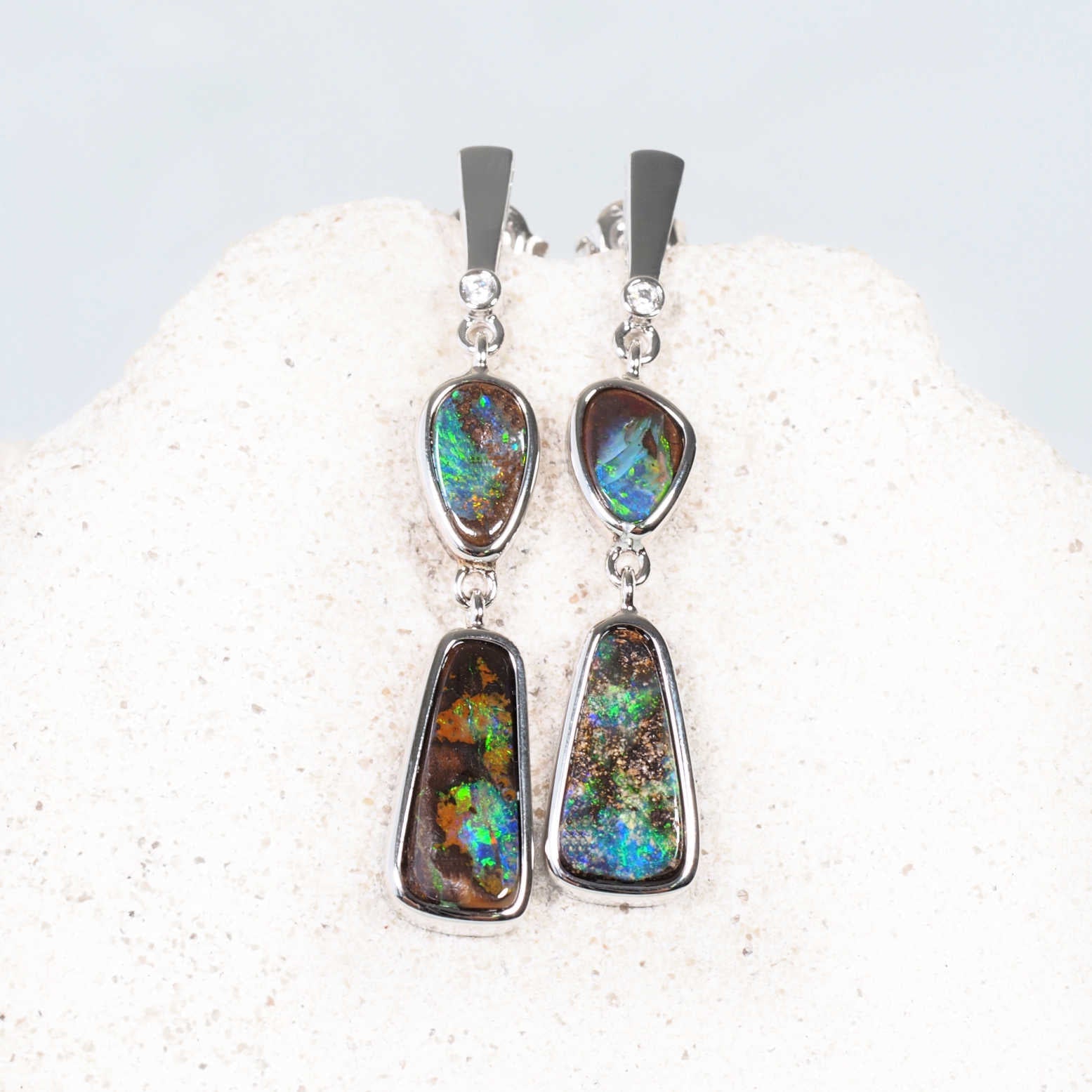 Close-up of blue and green Queensland boulder opals with natural ironstone backing