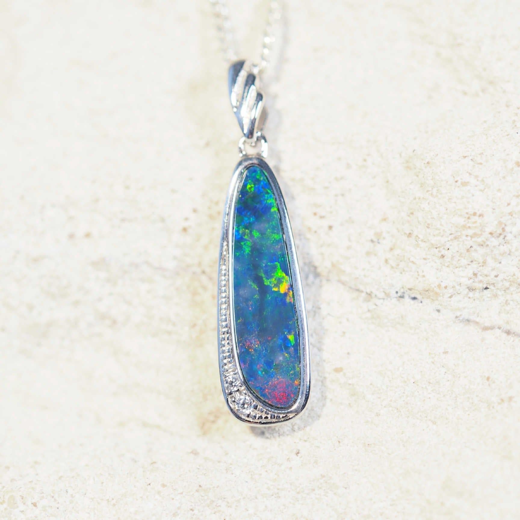 silver opal pendant set with a multi-colour opal