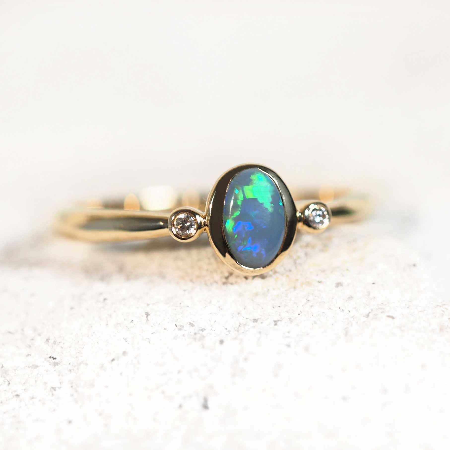 Australian semi-black opal ring with bezel setting and diamonds
