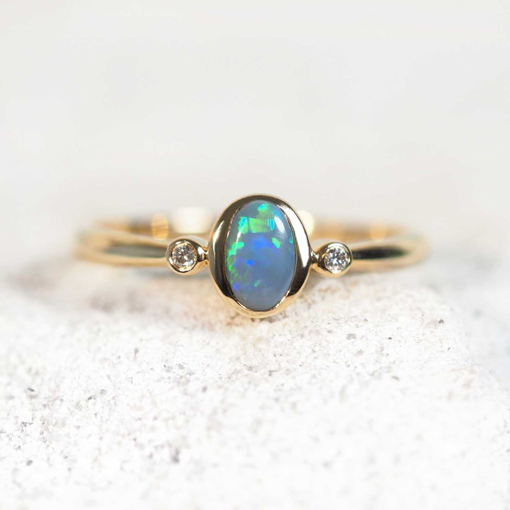 Opal ring with blue and green semi-black opal in 14ct yellow gold