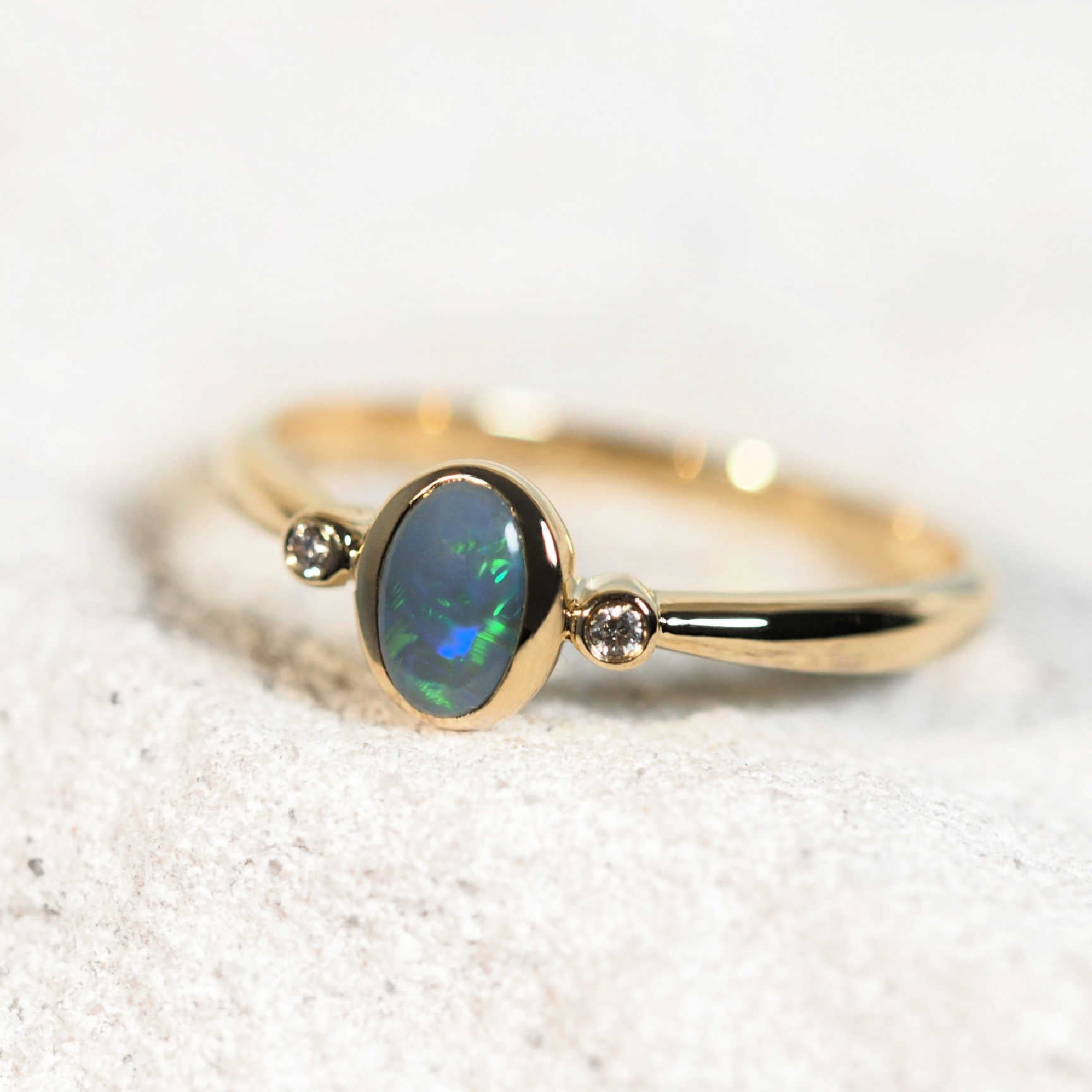 Close-up of the Blaire opal ring showing vivid opal fire and fine gold finish