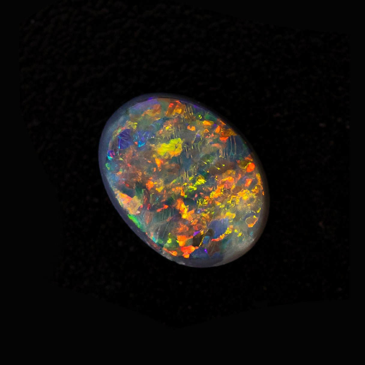 Bloomfire opal gemstone with electric blue and green hues