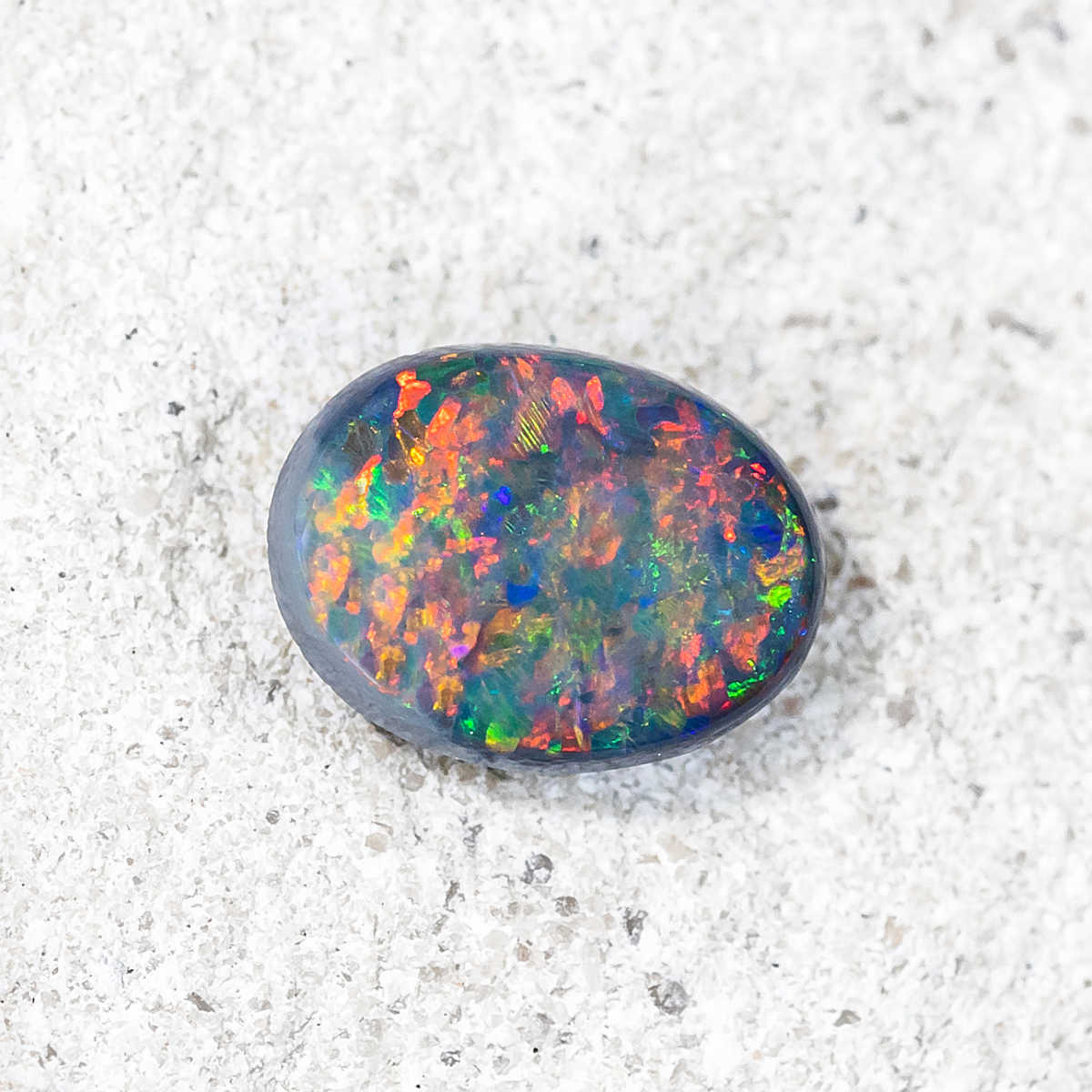Solid black opal with vibrant floral pattern from Lightning Ridge