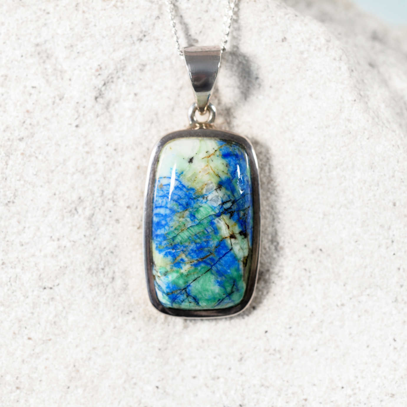 Close-up of 'Brea'  Azurite/Chrysocolla pendant highlighting the vibrant colours in a silver frame.