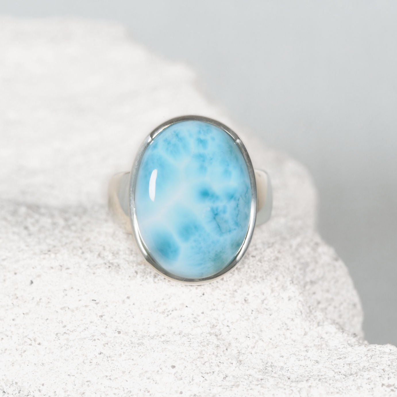 ‘Briar’ Blue Larimar ring with an oval gemstone showing soft white cloud-like streaks, set in polished silver