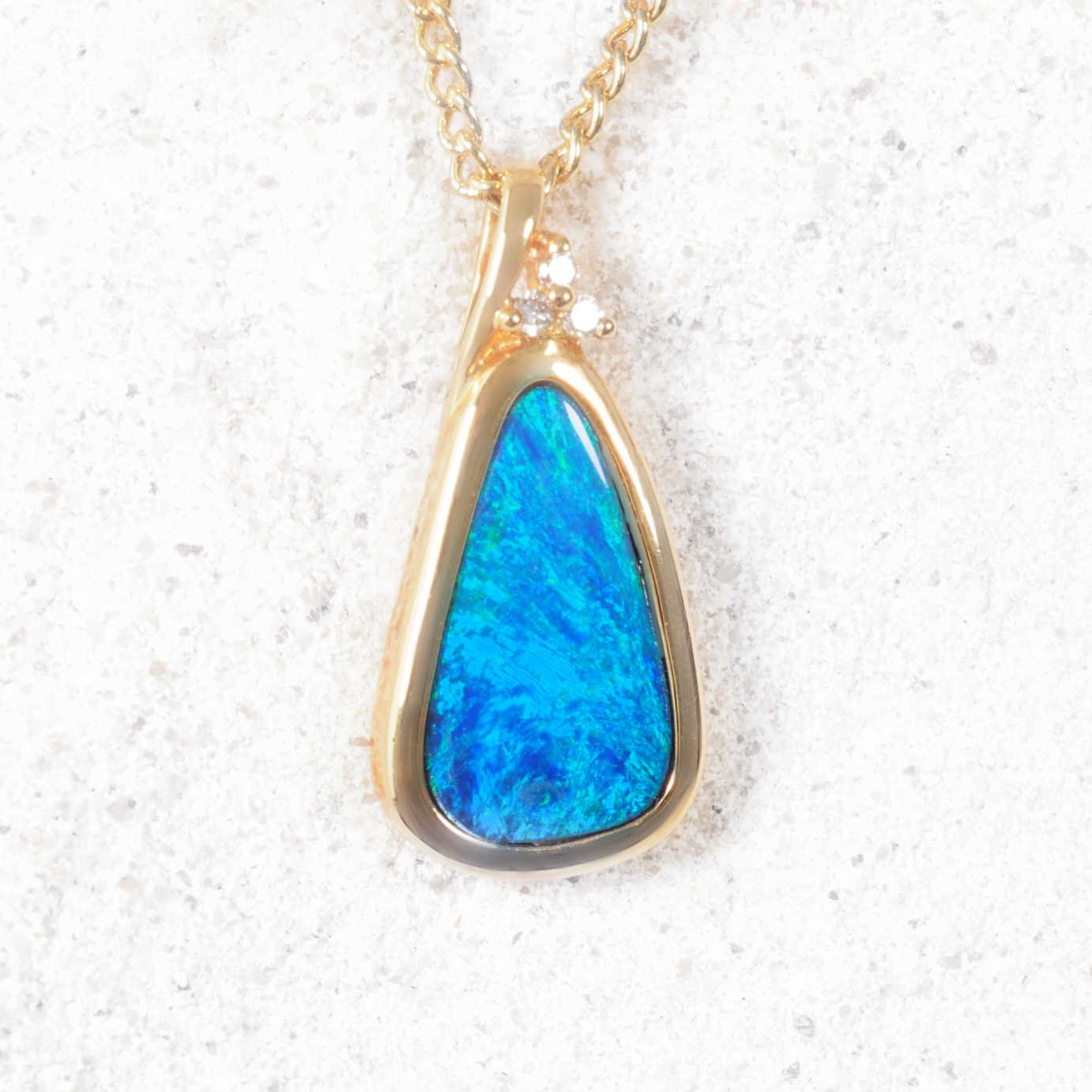 Caria 14ct gold opal and diamond pendant featuring a green teardrop doublet opal.