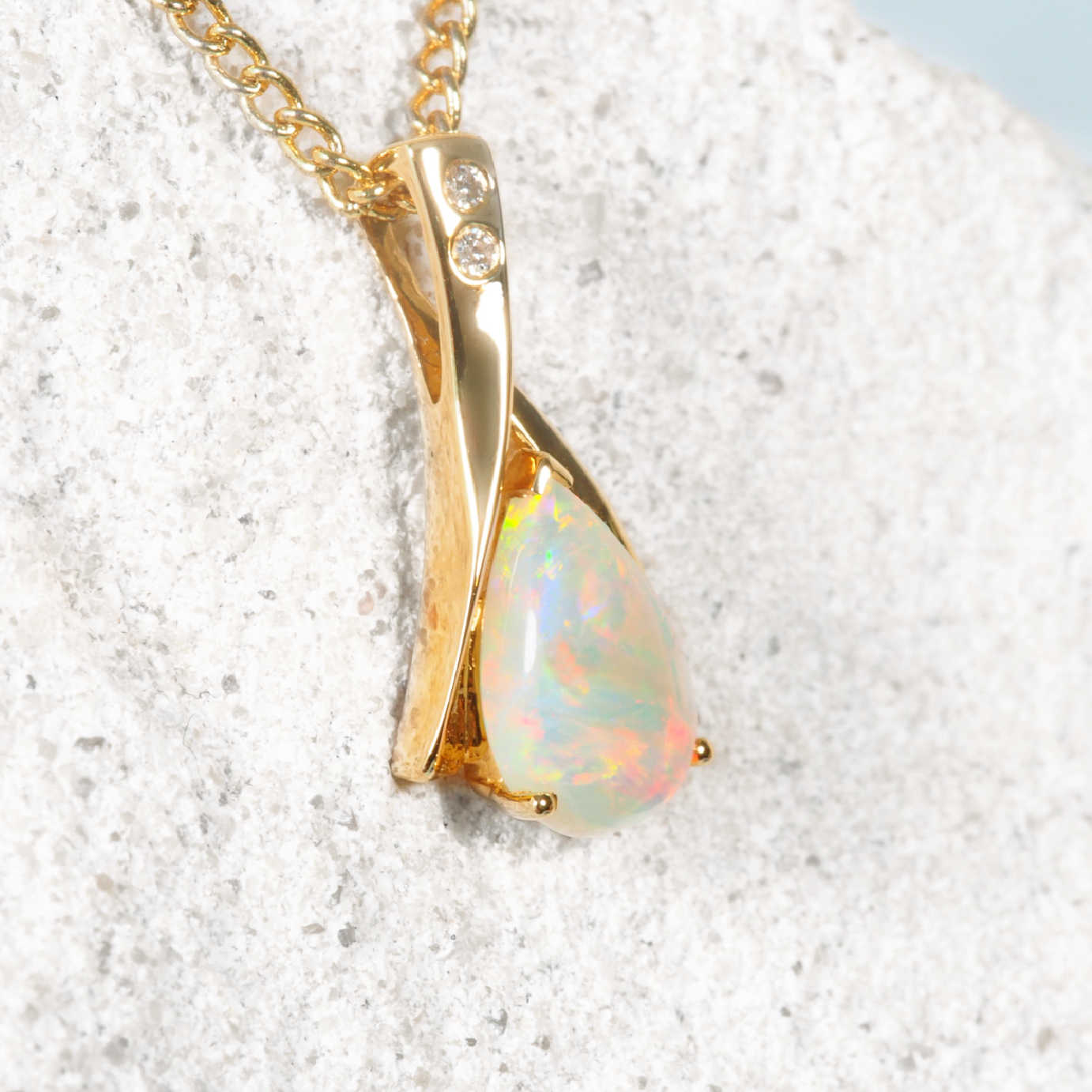 gold opal pendant set with two diamonds