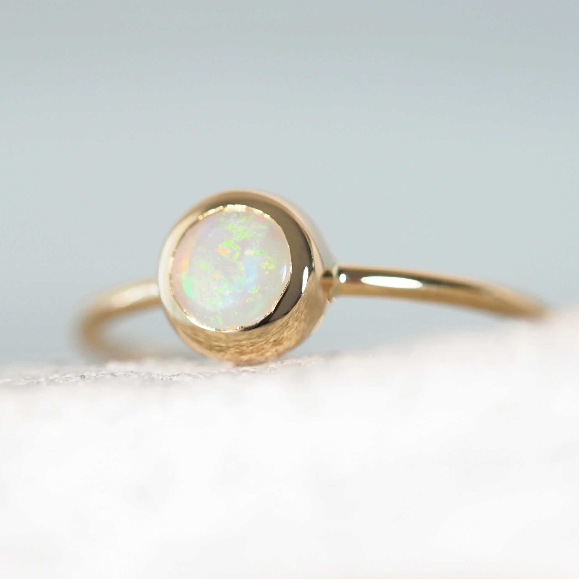contemporary design opal ring set in 14ct yellow gold