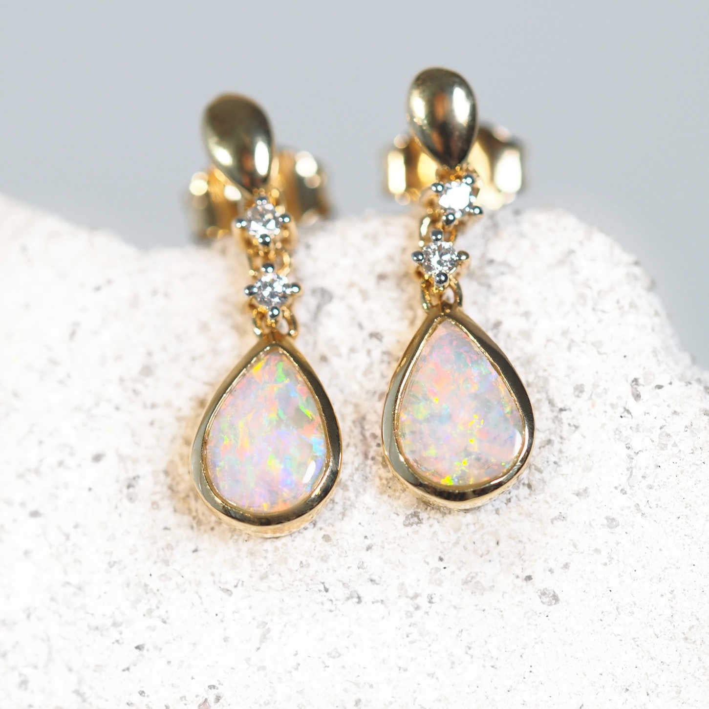 crystal opal earrings set in 18 carat yellow gold with diamonds