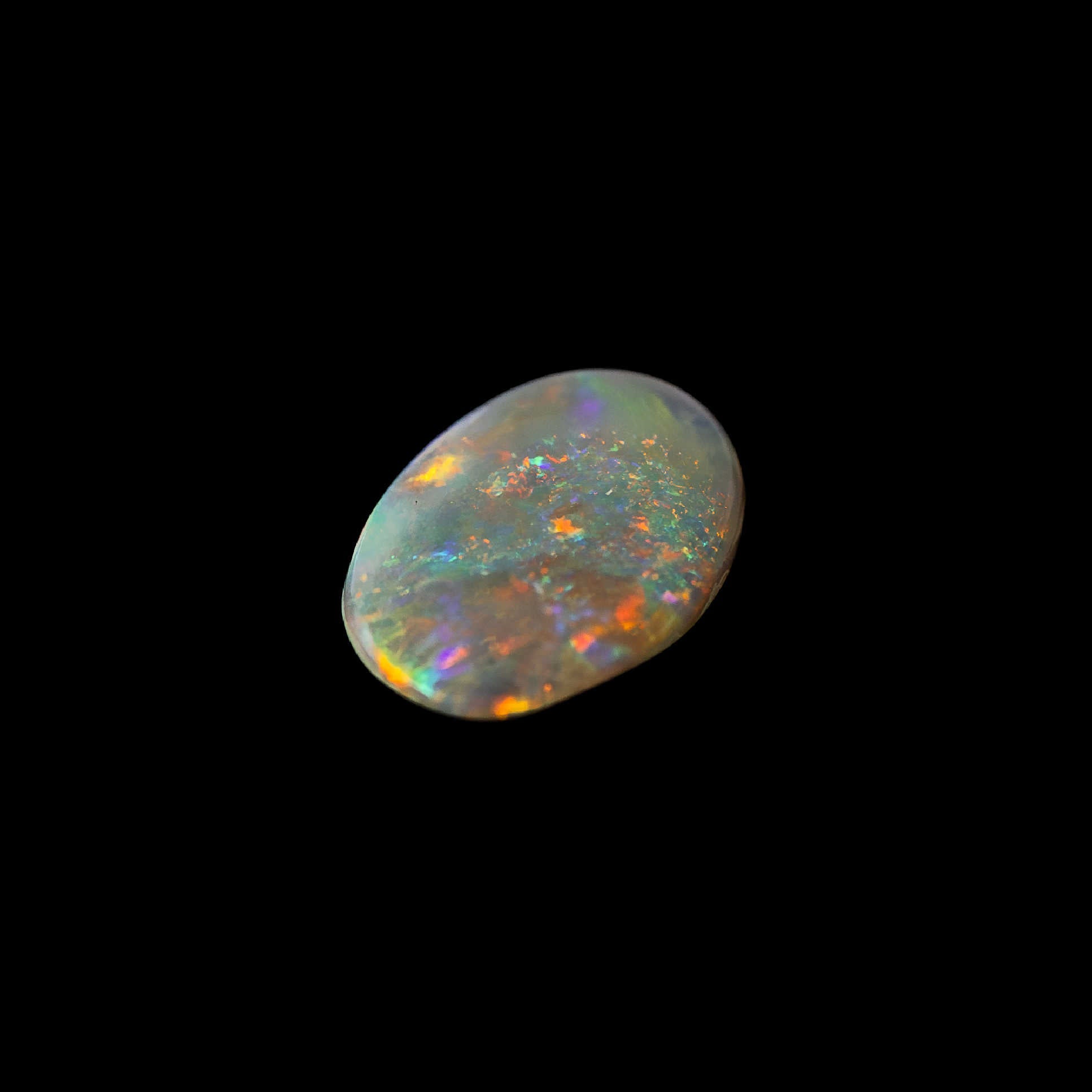 Oval-shaped Lightning Ridge crystal opal with bright flashes of red, green, blue, and gold