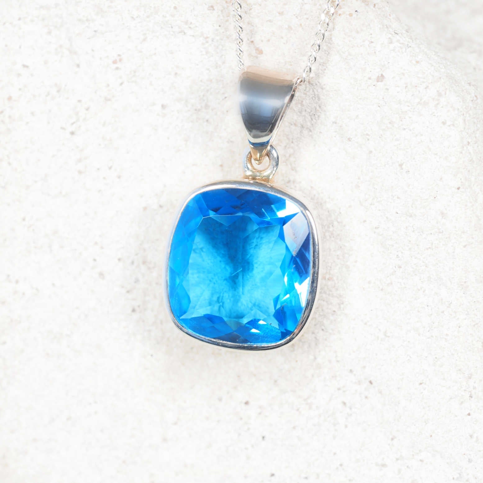 The 'Celeste' Light Blue Topaz square pendant in silver bezel, perfect for casual and formal wear