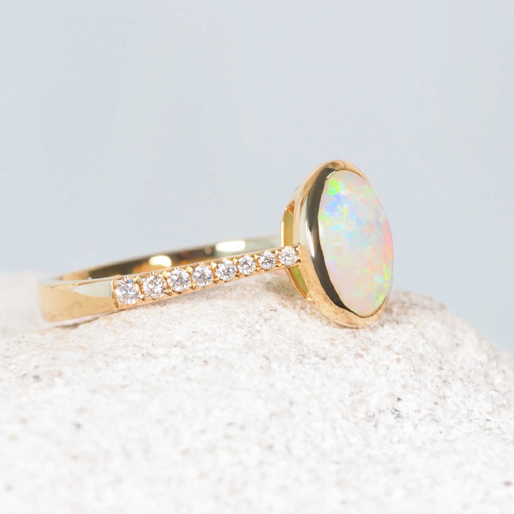 Side view of South Australian crystal opal ring with yellow gold and diamond detail