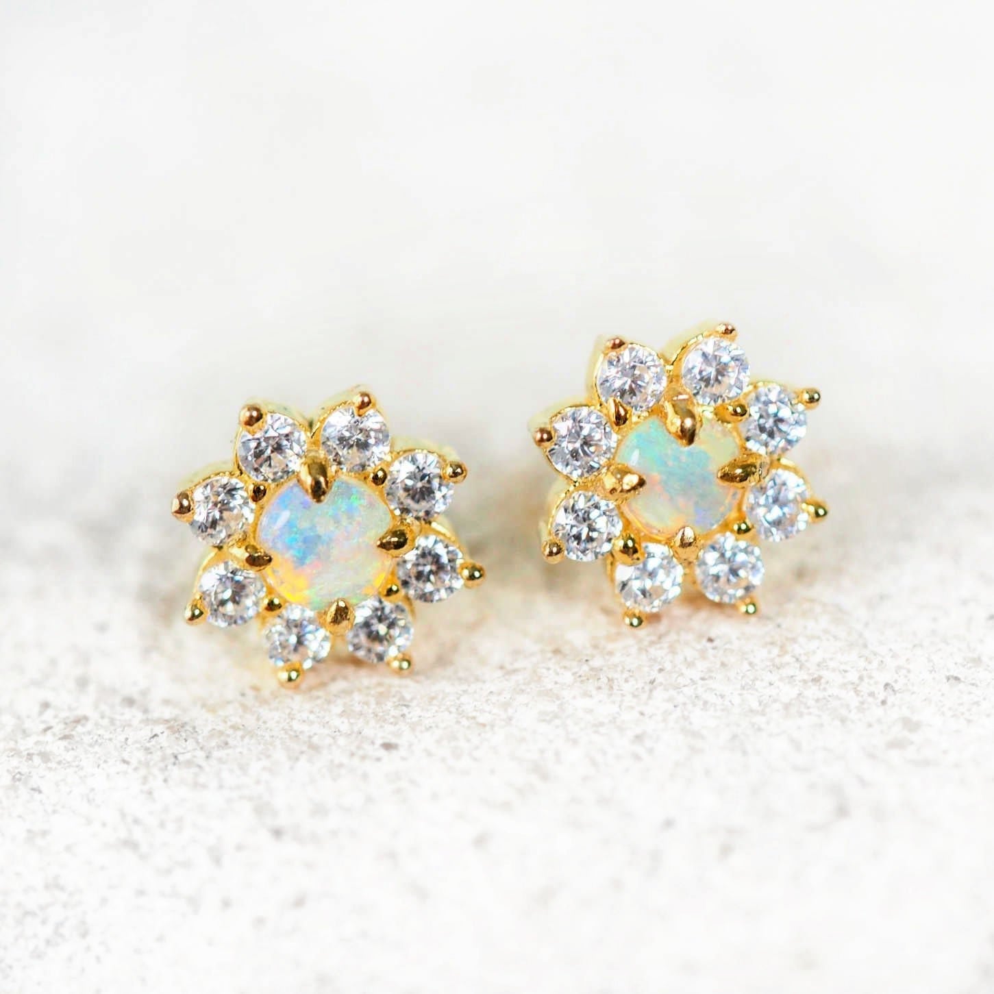 Celestia opal earrings in gold-plated silver featuring vibrant blue and green Australian solid crystal opals surrounded by eight sparkling diamantés