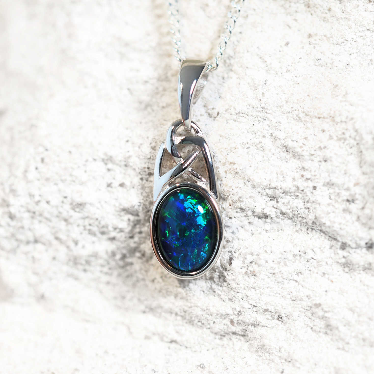 celtic design opal pendant with a blue opal