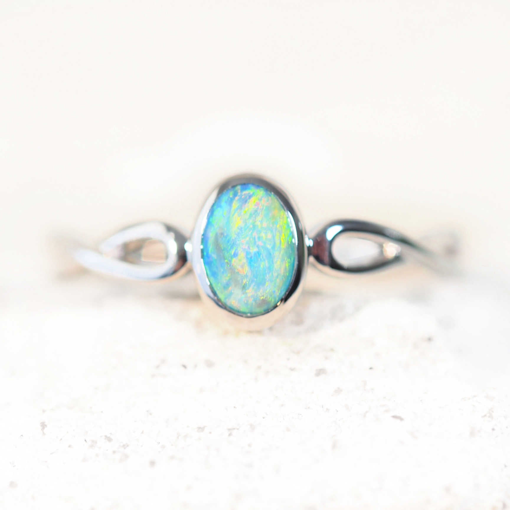 close up of colourful opsl ring set in white gold