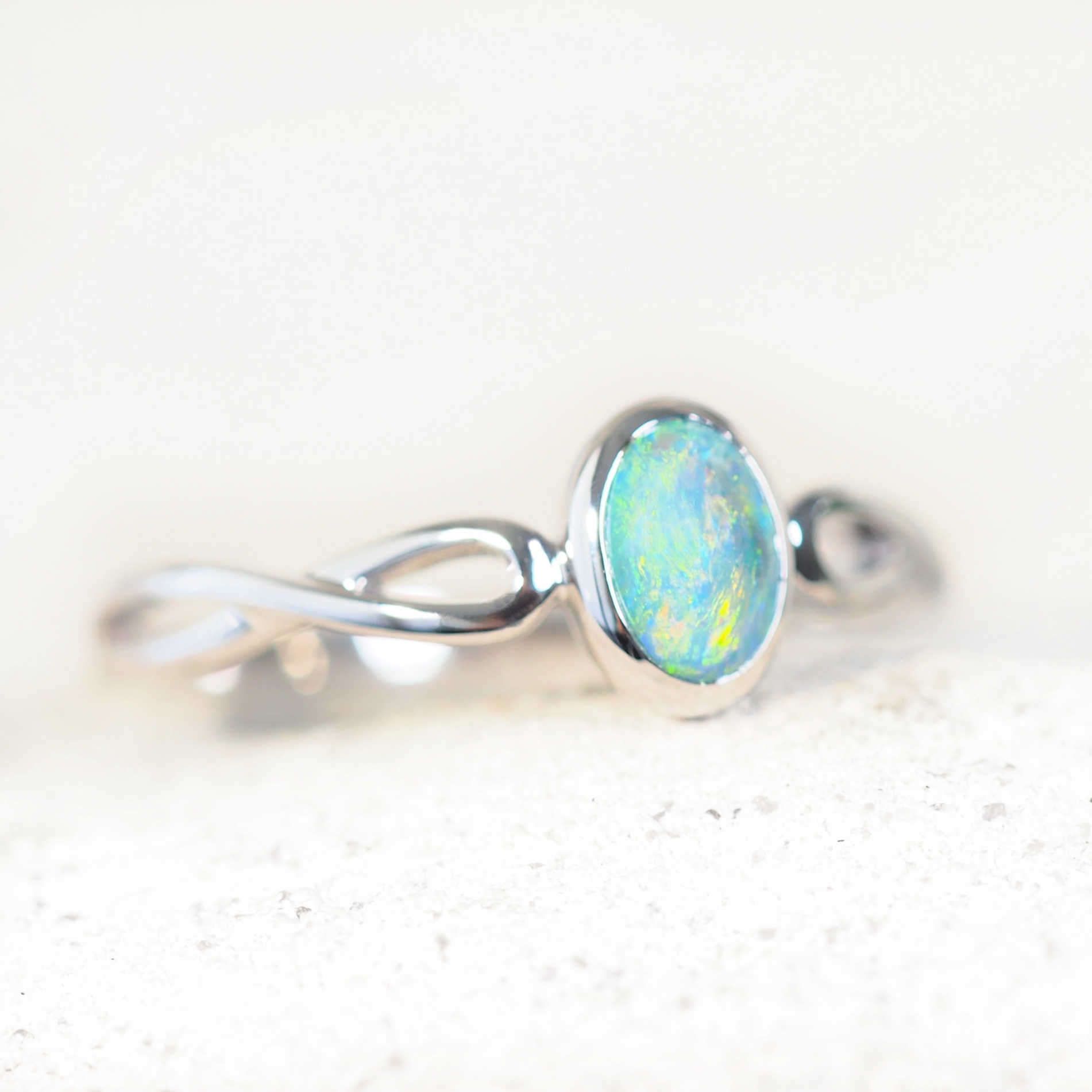 oval lightning ridge opal ring set in white gold