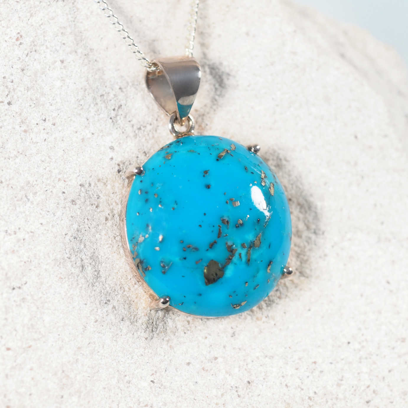 Persian Turquoise Pendant with a claw set design