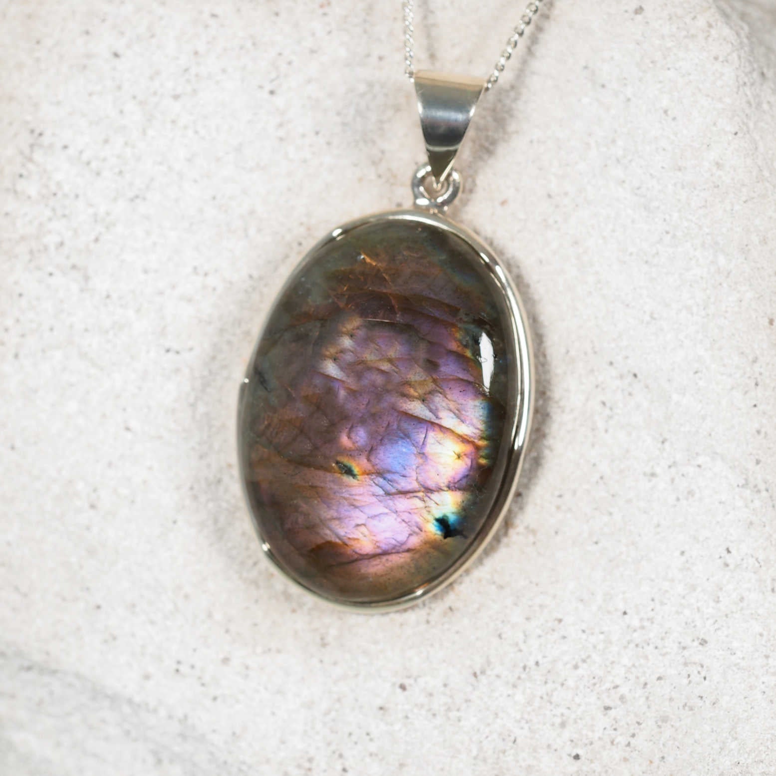 Labradorite pendant displaying purple with blue hues