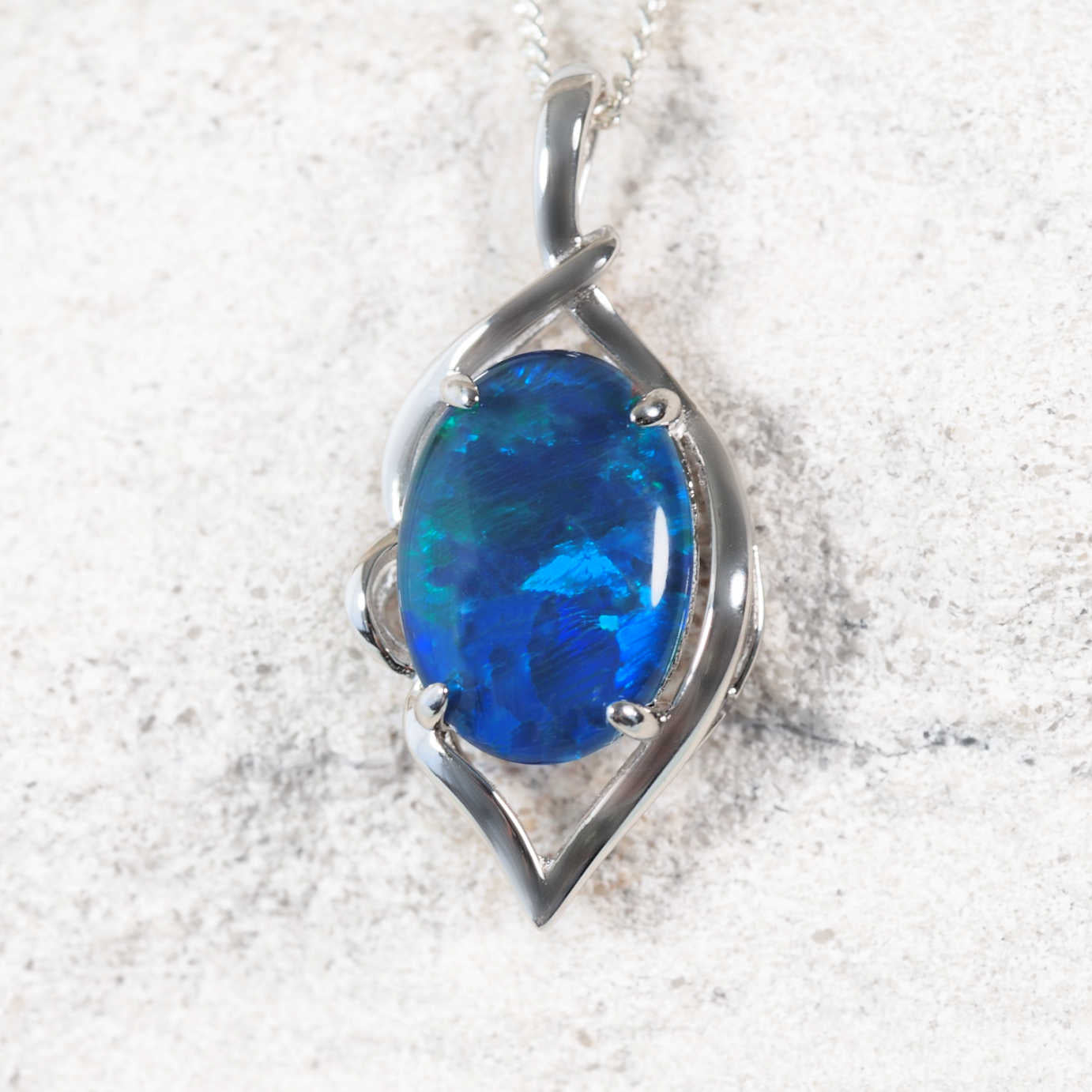 Statement opal necklace pendant in sterling silver featuring claw-set blue and green Australian triplet opal