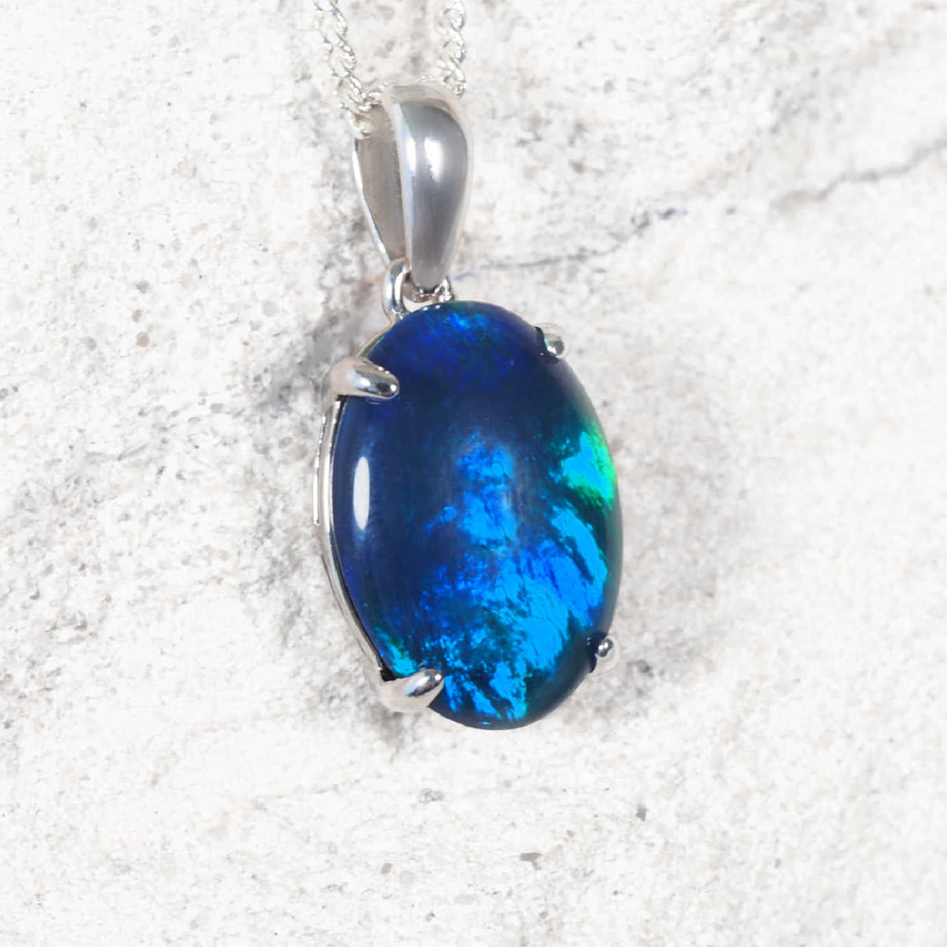 Classic 'Grande Blue' sterling silver opal pendant with claw-set oval Australian triplet opal glowing in vivid blue and green flashes, statement necklace design