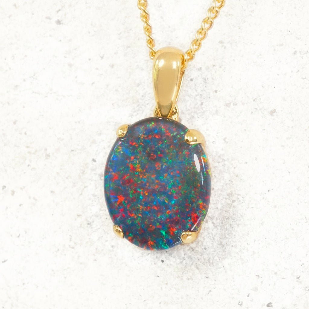 Opal pendant with gold frame on a white background