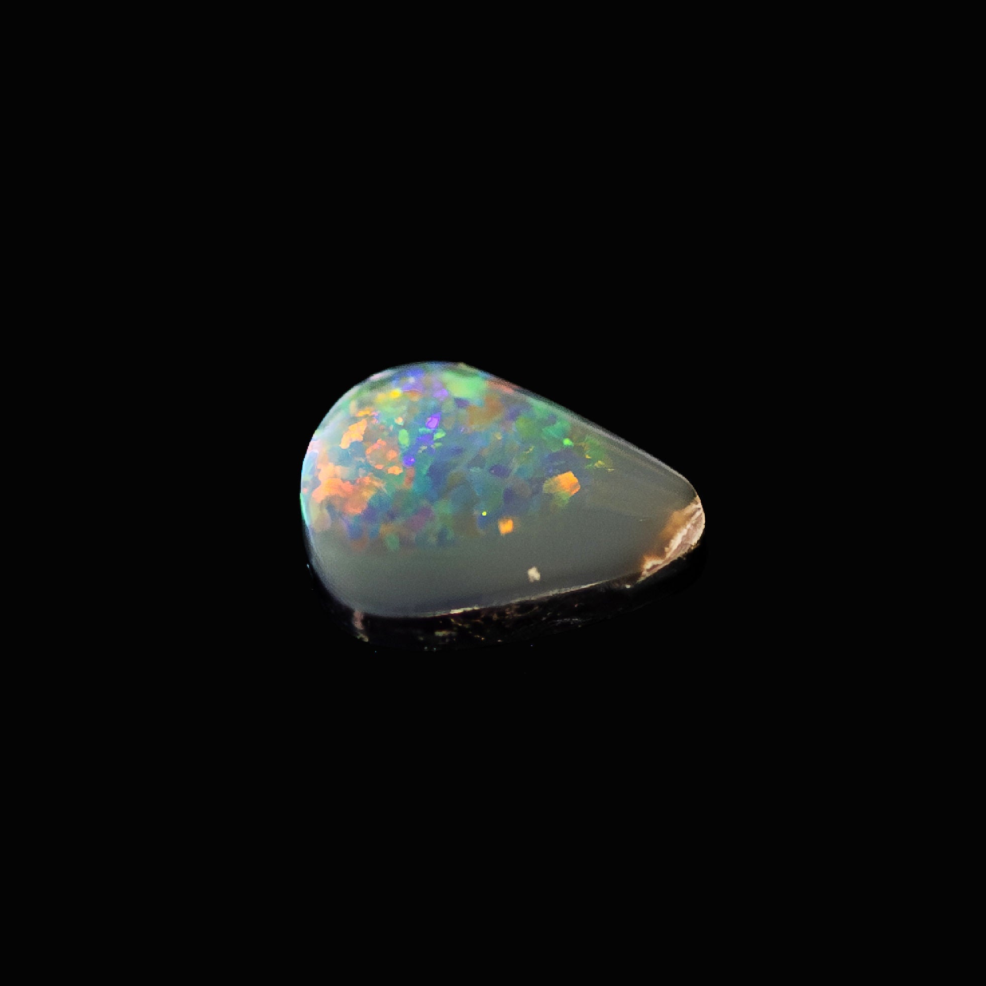 Teardrop Australian semi-black opal with electric flashes of colour