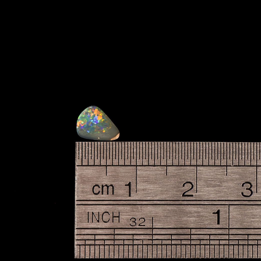 Rare solid opal gemstone featuring charcoal body and vivid play-of-colour