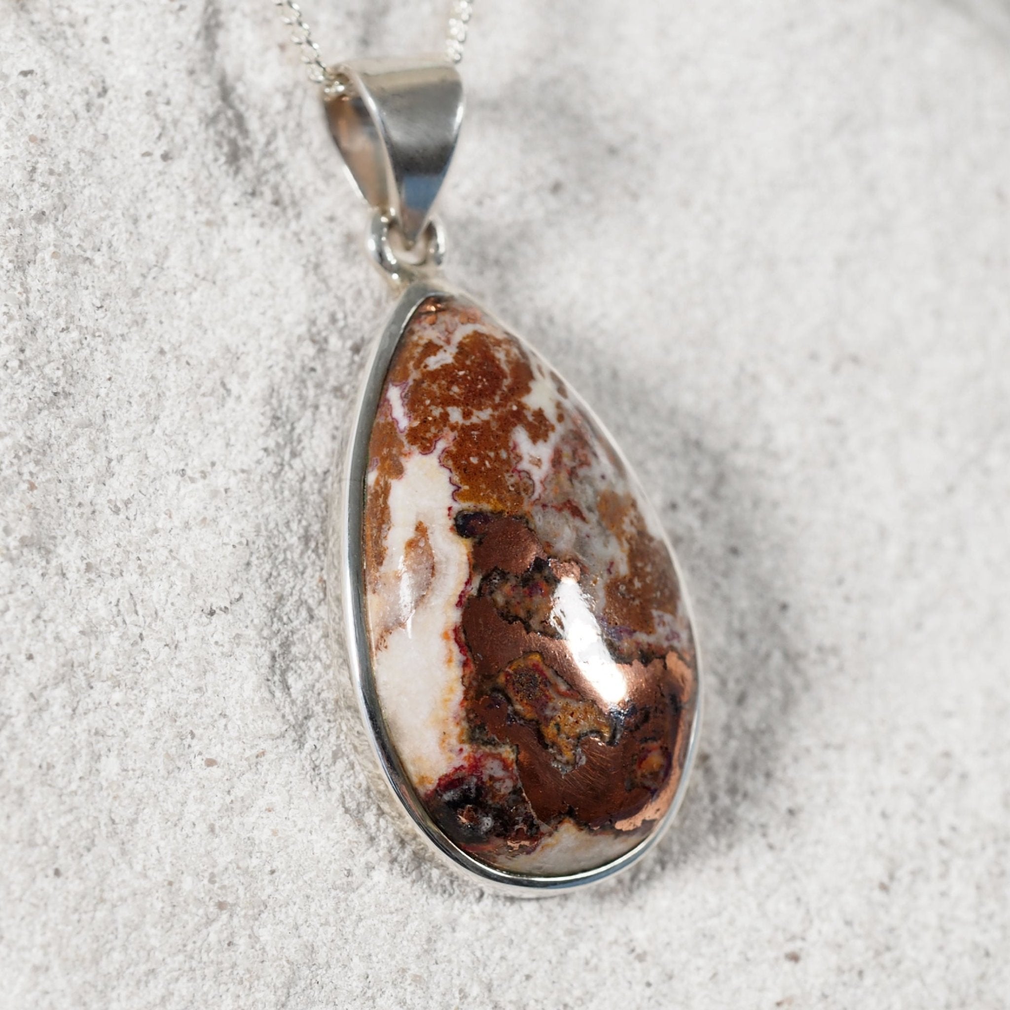'Corina' Pendant featuring a copper dolomite gemstone with a silver bezel setting the stone in place