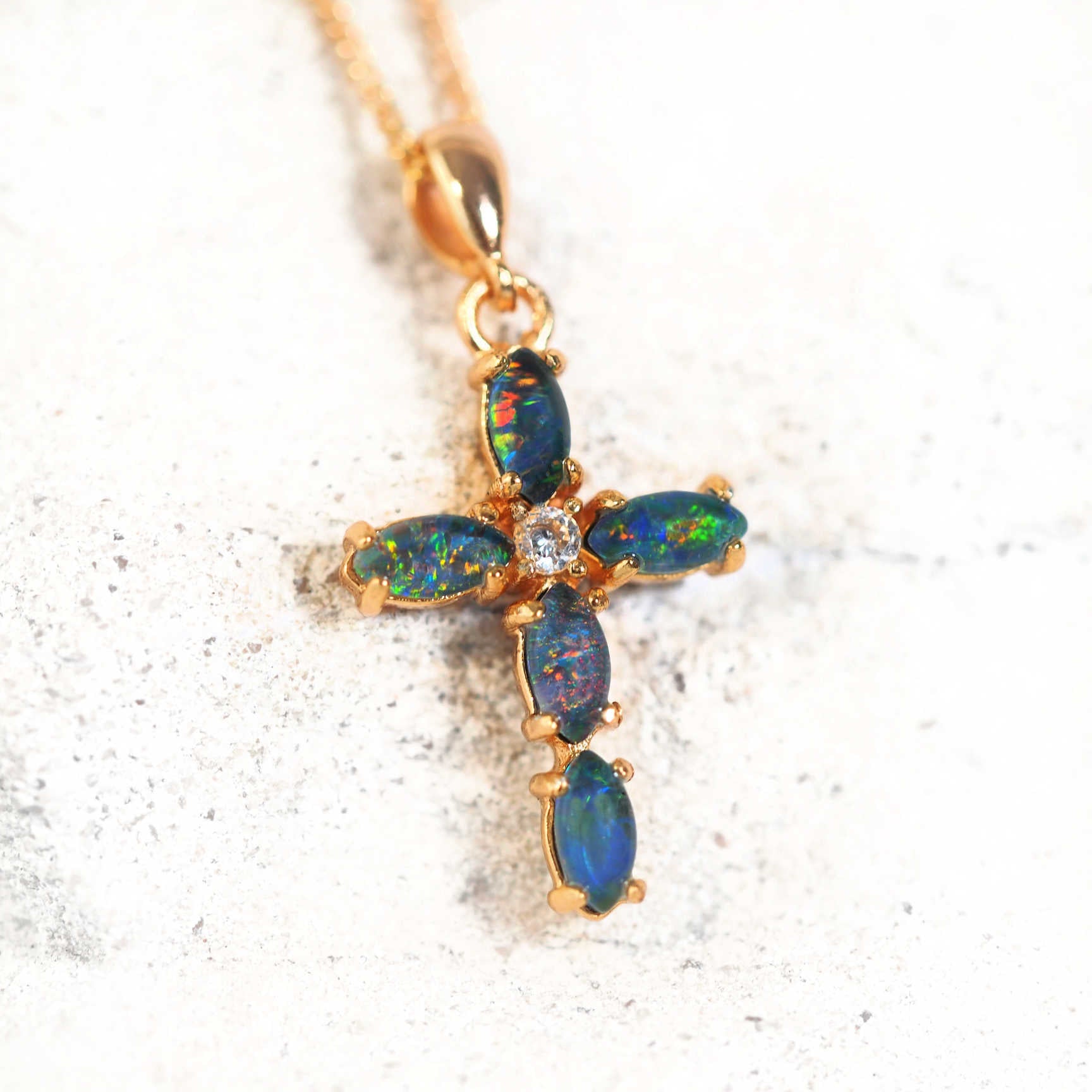 Gold plated silver cross opal pendant with five marquise-shaped Australian triplet opals and a central sparkling cubic zirconia.