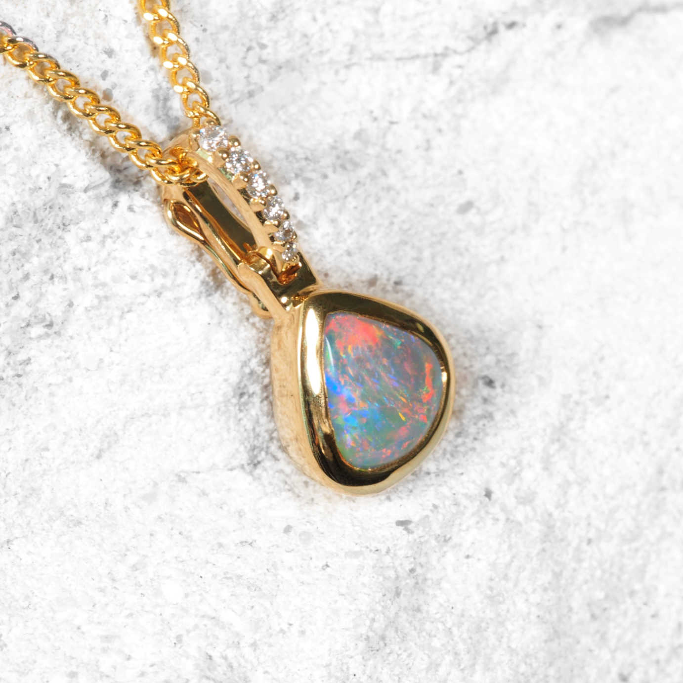 Petite Australian opal pendant with vivid red, green, and blue flashes