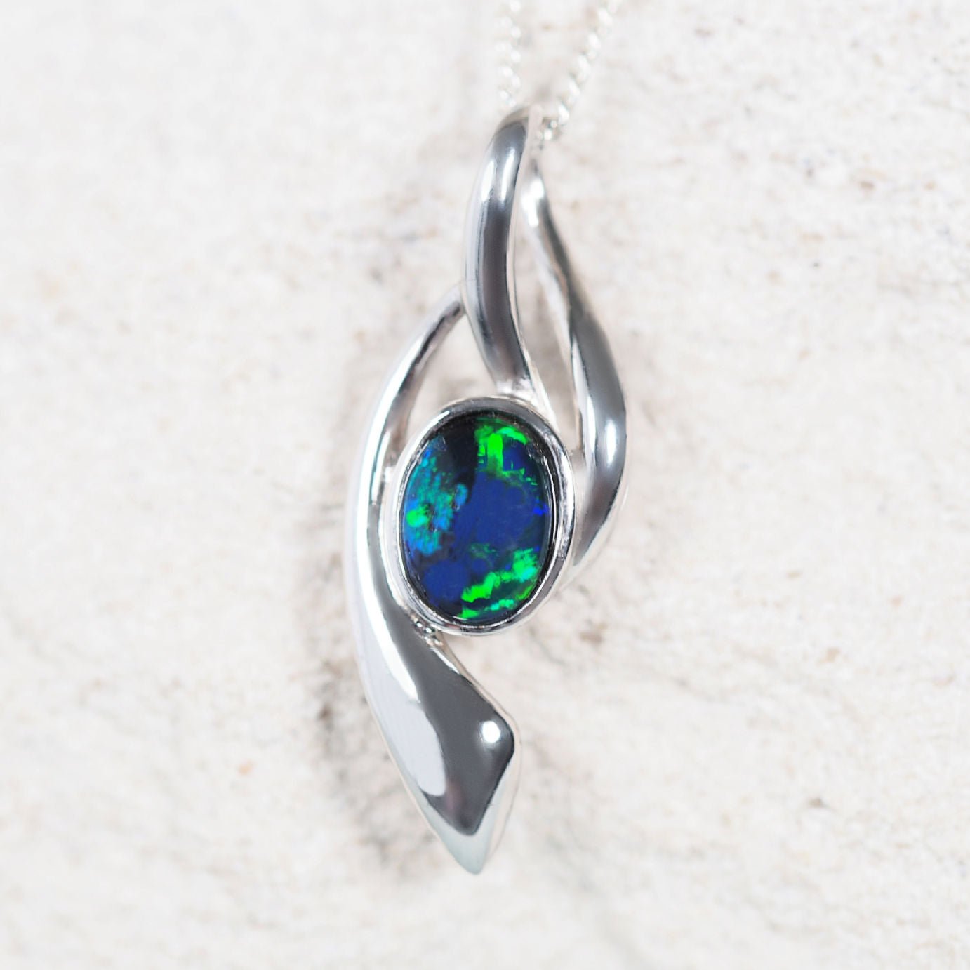 ‘Deena Blue’ sterling silver opal pendant with claw-set oval Australian triplet opal in vivid blue and green tones