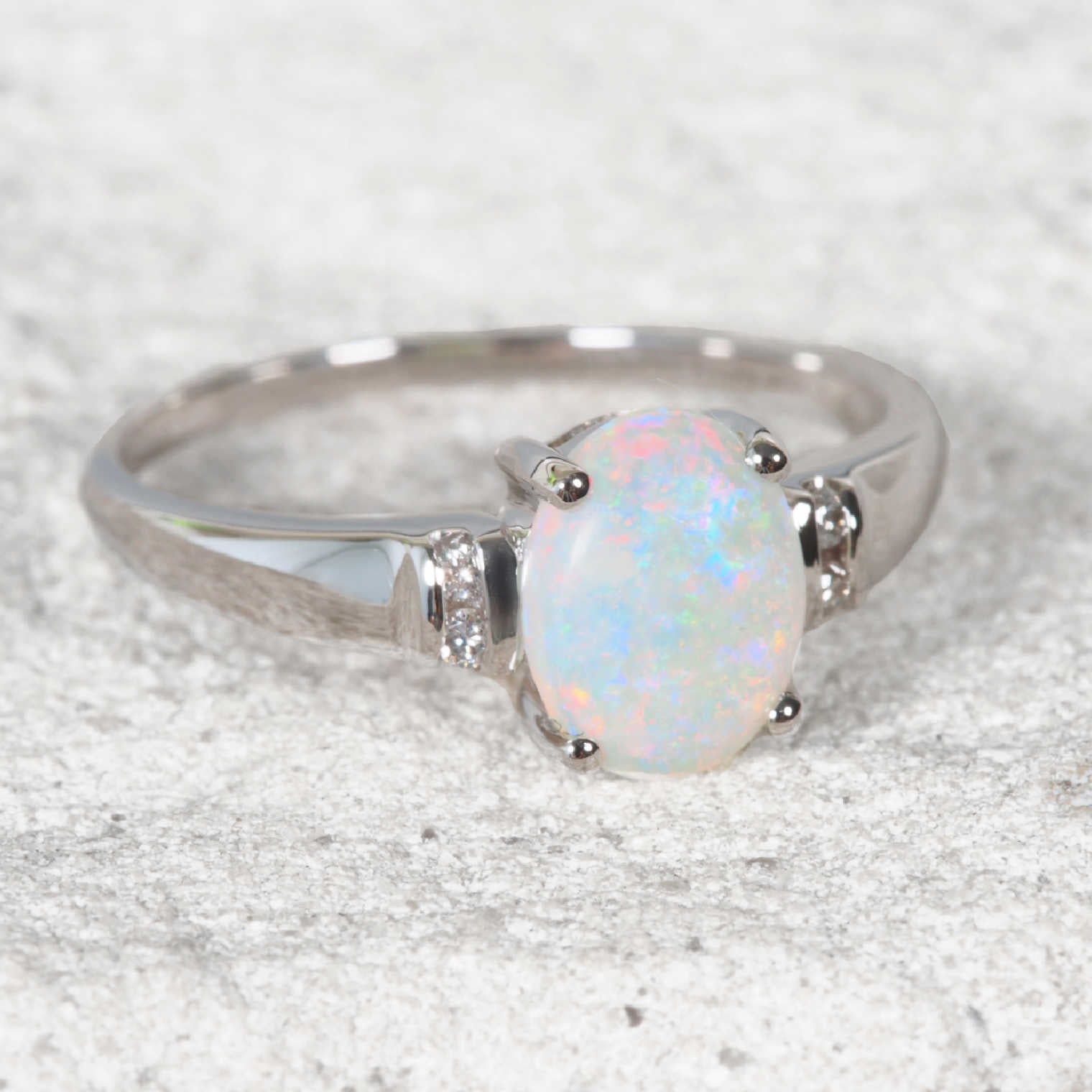 white opal ring set in white gold with diamonds