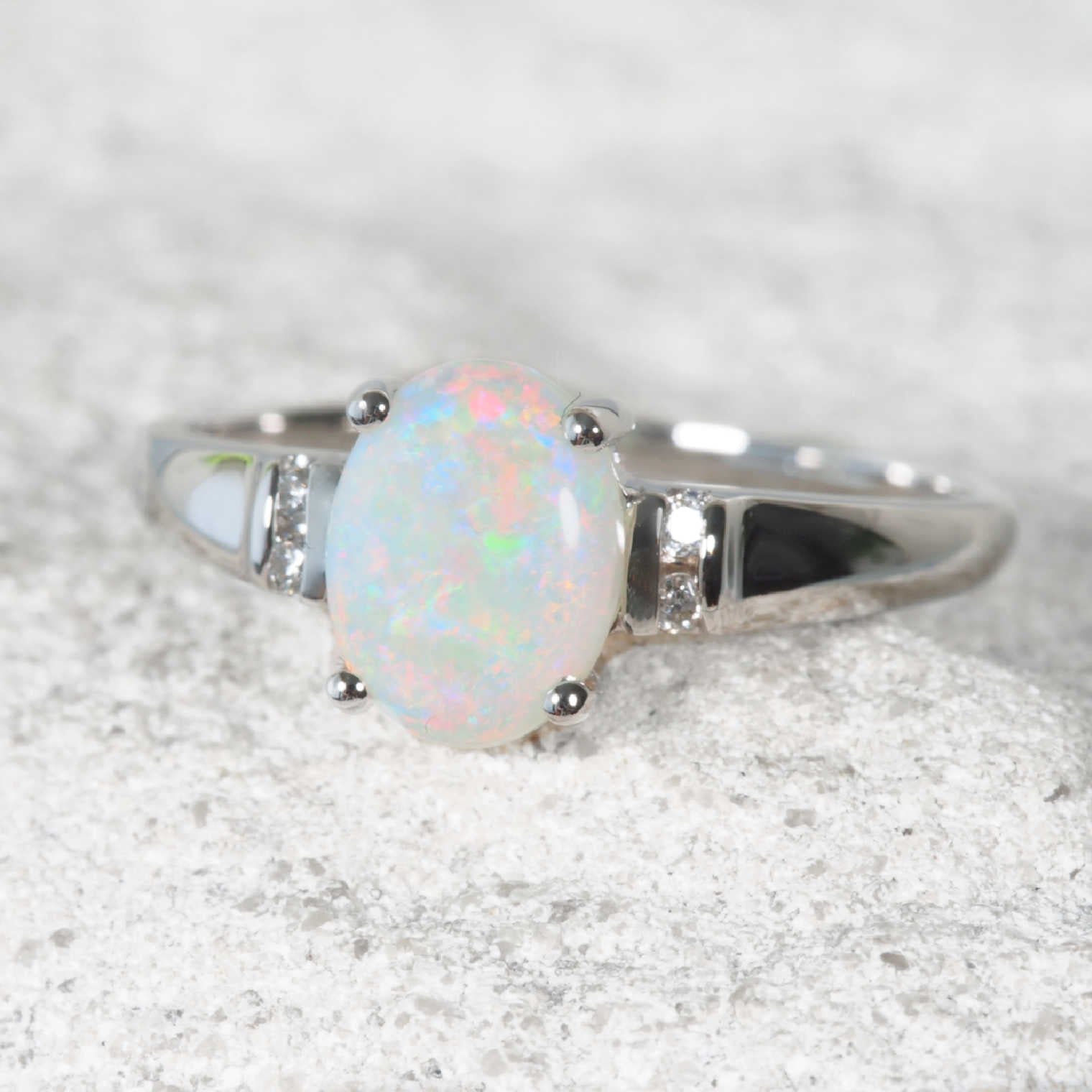 Australian natural opal with diamonds sitting in white gold