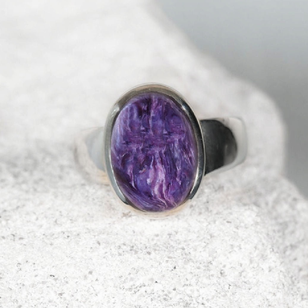 Charoite Gemstone ring displaying deep purple swirls in a silver frame