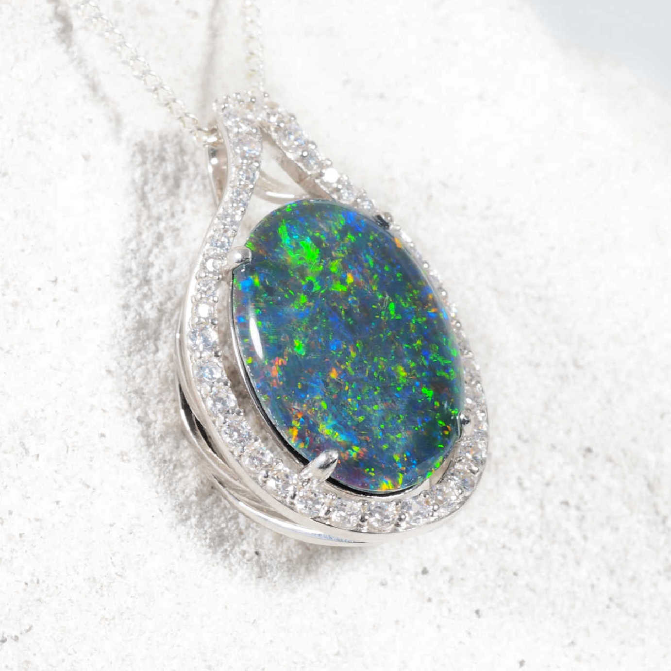 Statement opal necklace pendant in sterling silver featuring claw-set Australian triplet opal with vivid play-of-colour and diamanté halo