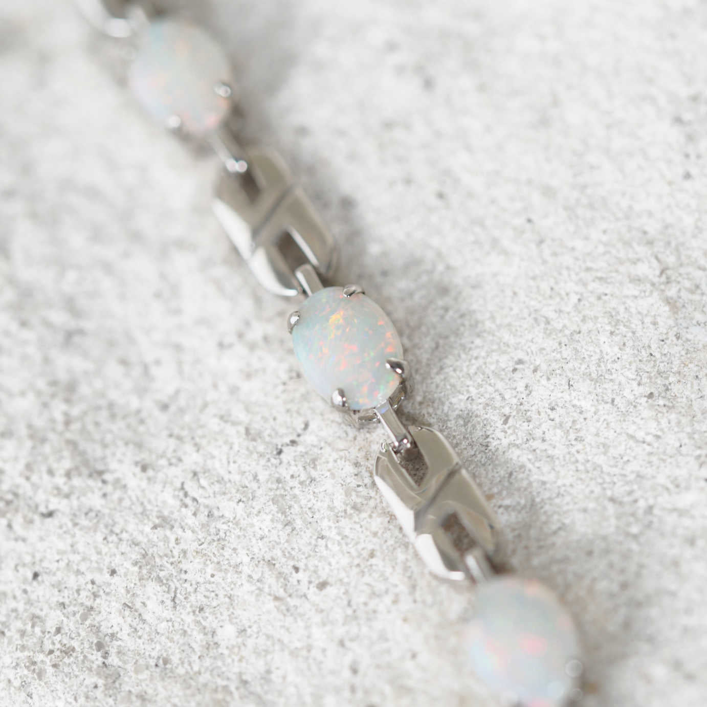Opal bracelet on a textured white surface