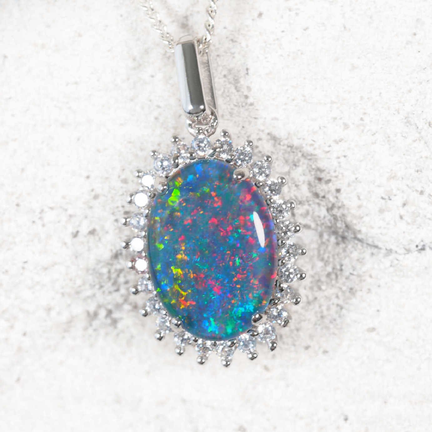 ‘Duchess’ sterling silver opal pendant with claw-set oval Australian triplet opal and halo of 26 sparkling cubic zirconias