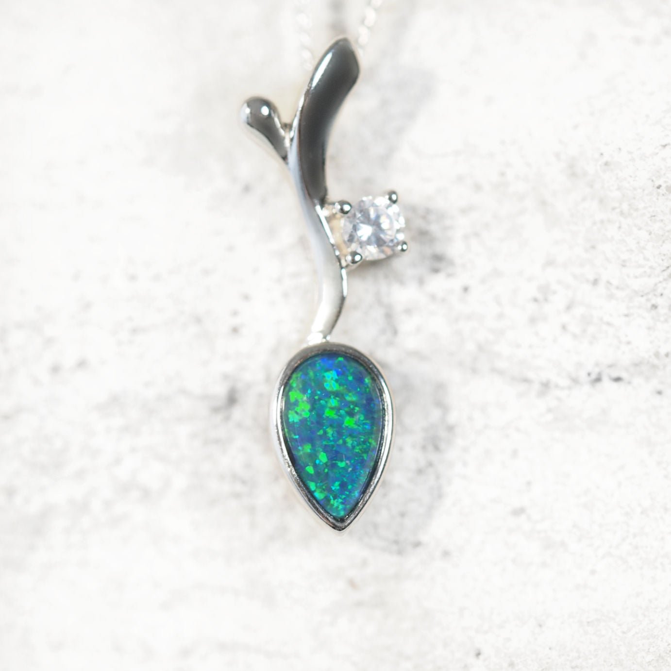 'Eden Blue' opal pendant in sterling silver with bezel-set teardrop Australian triplet opal in vivid blue and green tones with diamanté accent