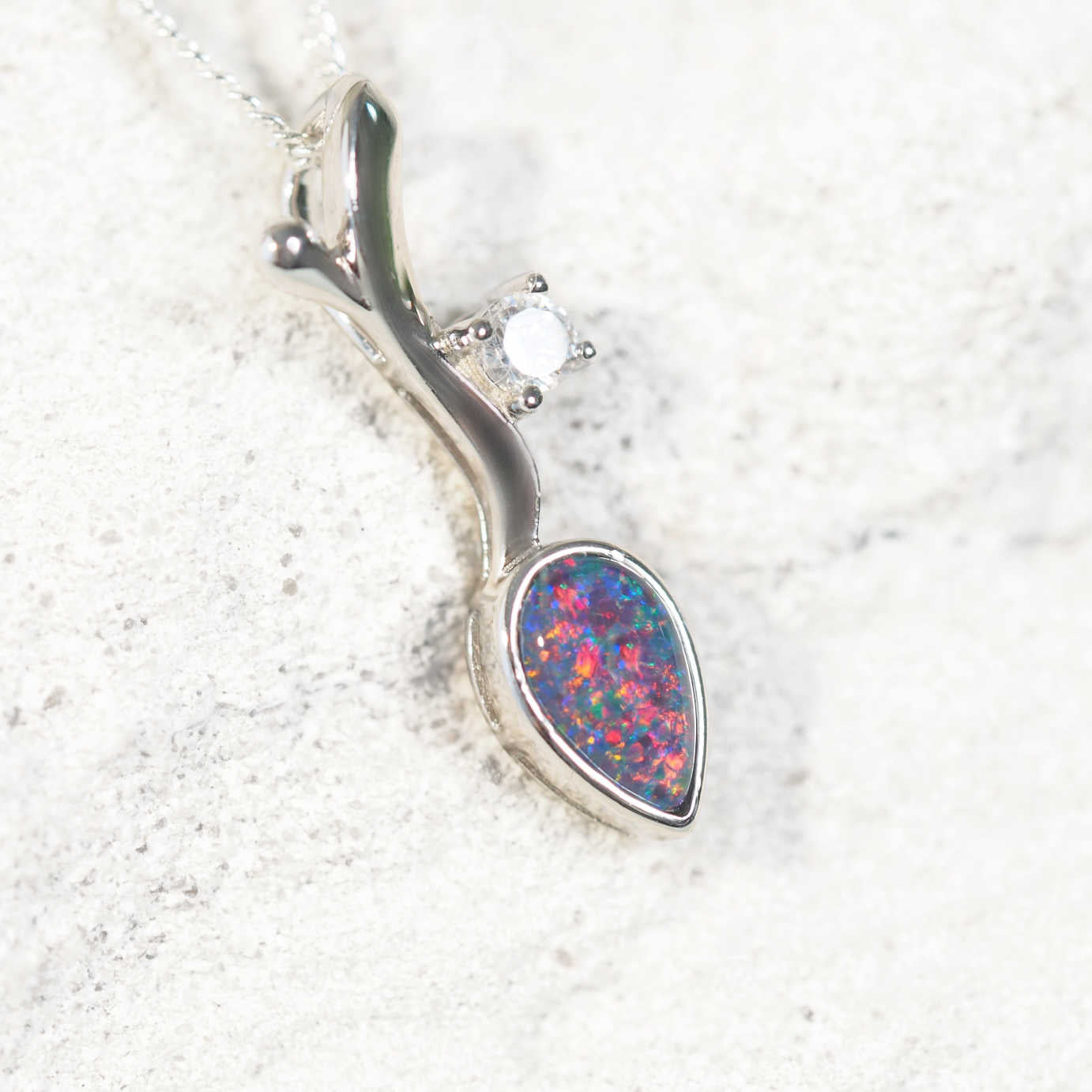 'Eden' opal pendant in sterling silver with bezel-set teardrop Australian triplet opal in multi-coloured tones and sparkling diamanté accent