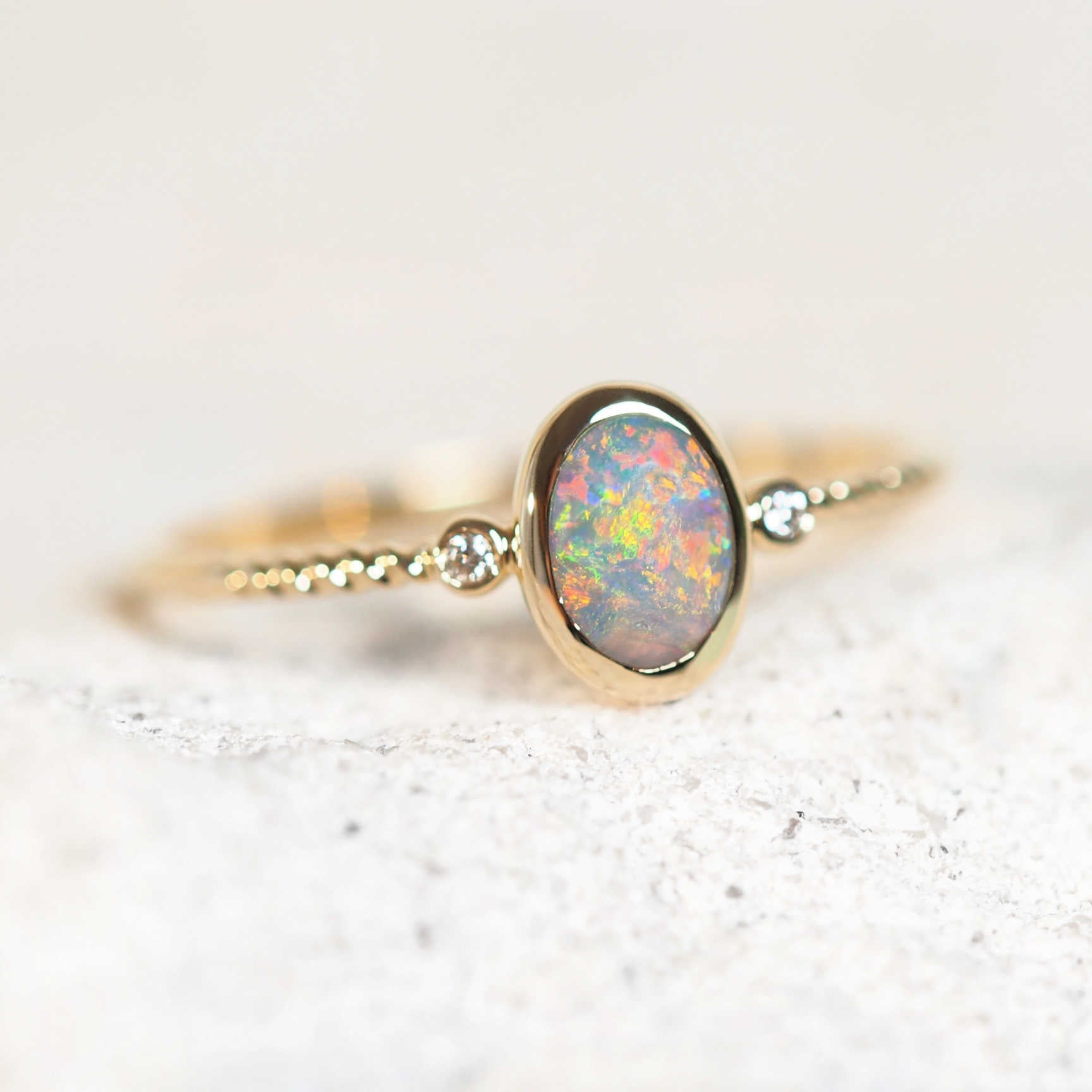 black opal ring featuring a colourful floral pattern