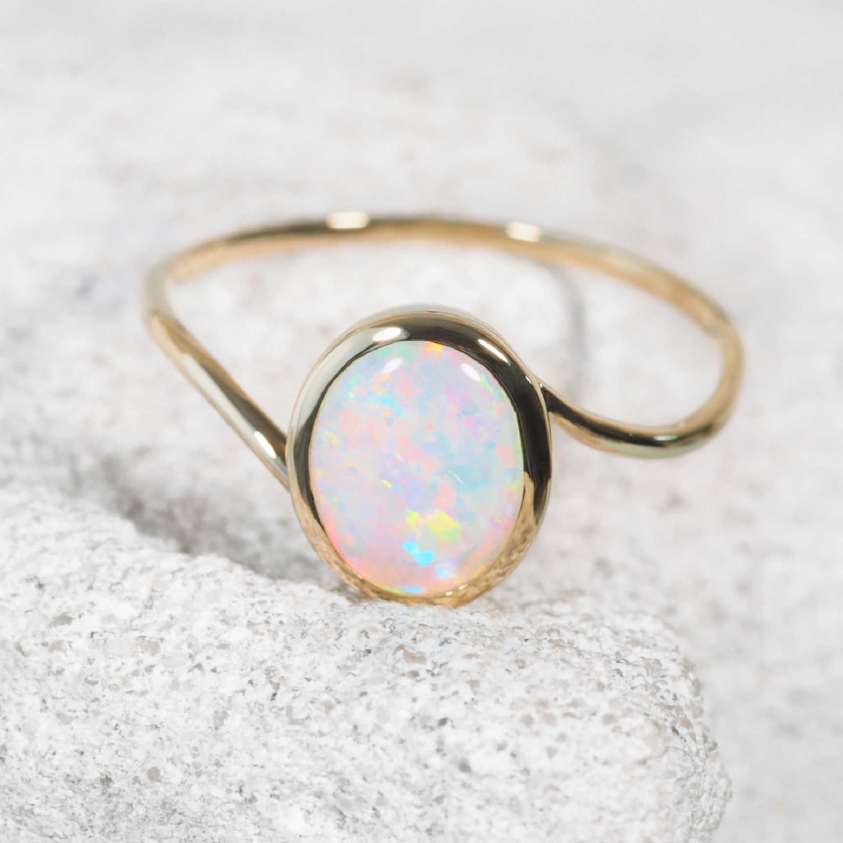 Elara ring in natural light highlighting play-of-colour in opal gemstone