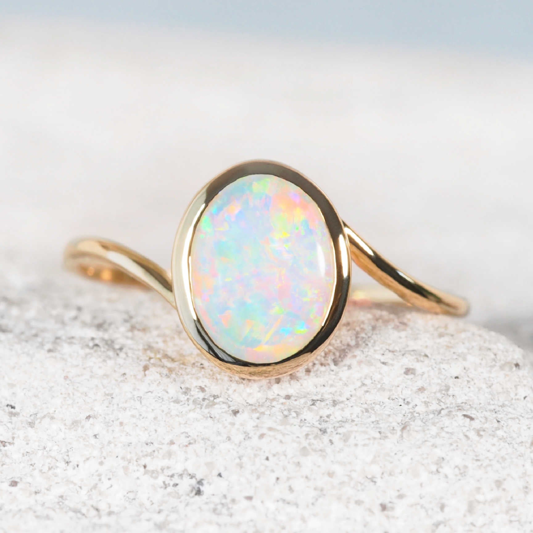 Elara opal ring with oval crystal opal in 14ct yellow gold split band