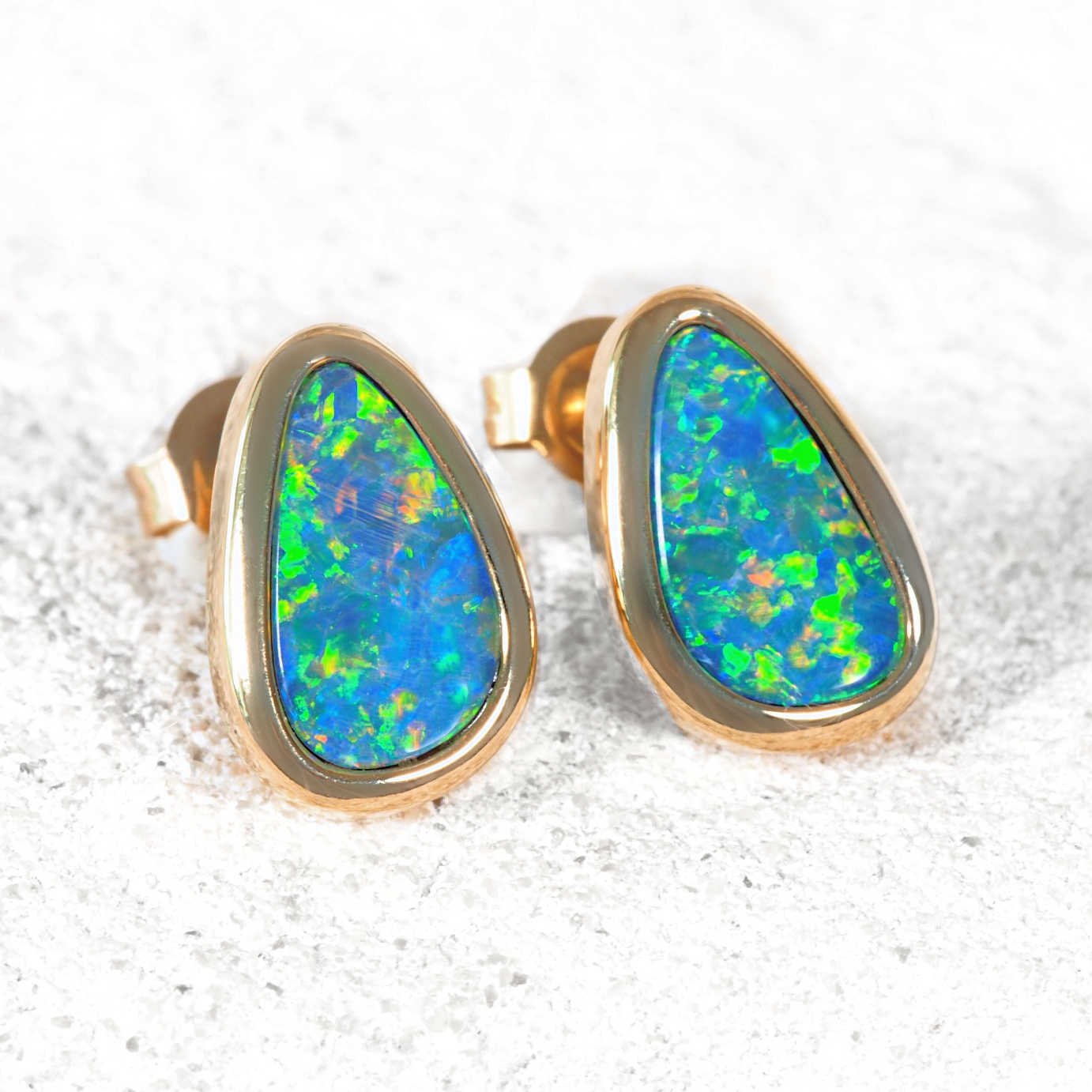 Teardrop-shaped Australian doublet opal earrings in solid 14ct yellow gold.