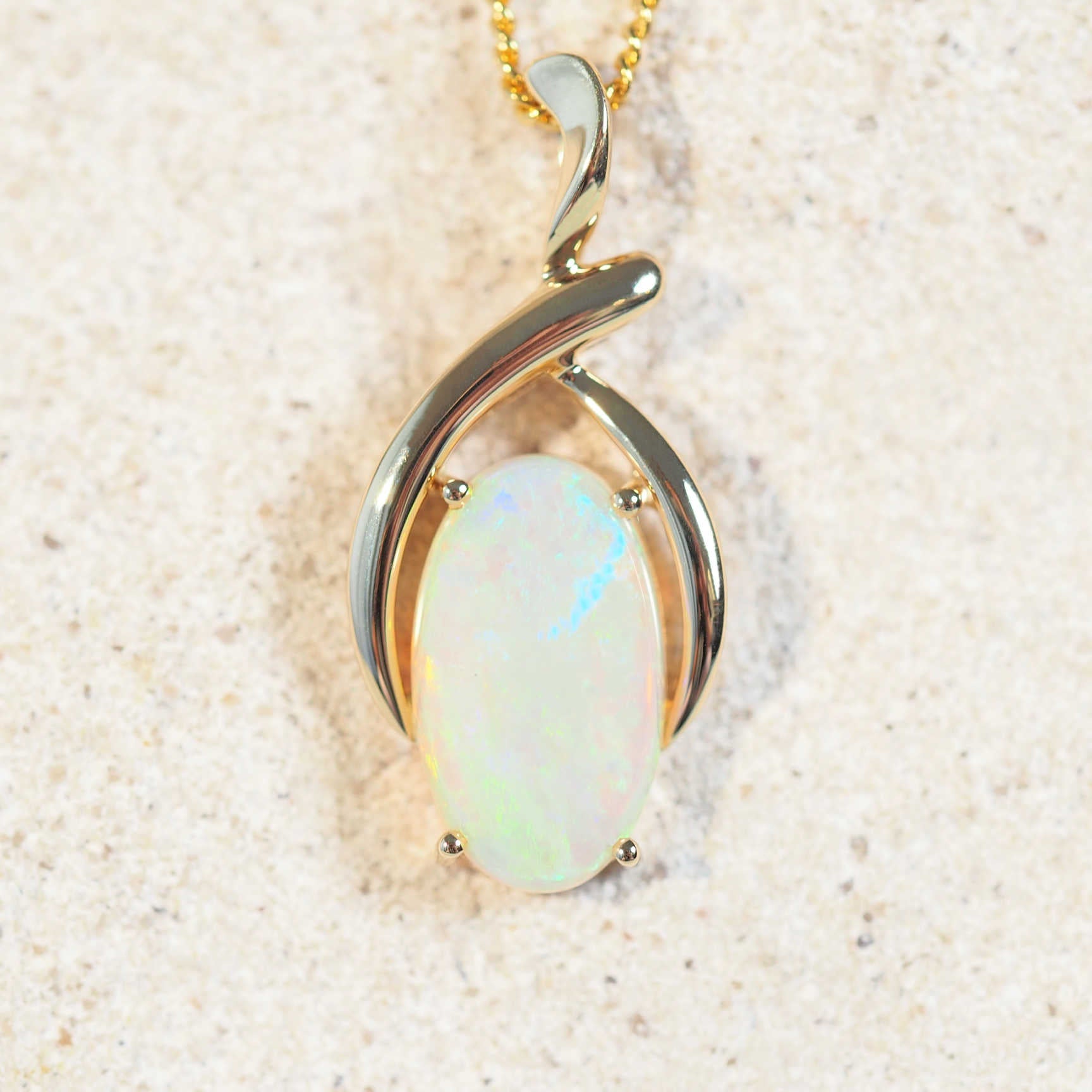 oval opal pendant set in 14ct yellow gold