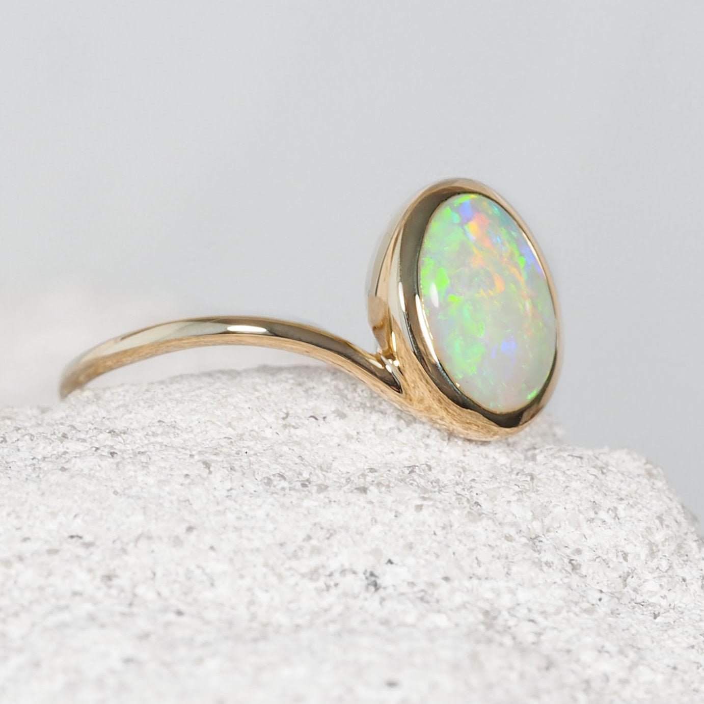 Genuine Australian crystal opal gold ring with a solid Coober Pedy opal in a contemporary 14ct yellow gold bezel setting