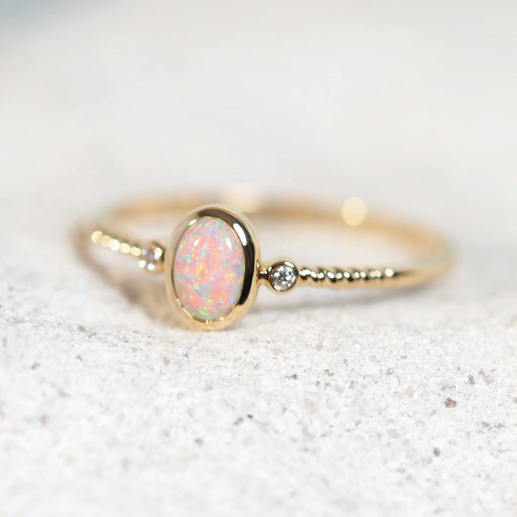 Delicate gold opal ring with oval Lightning Ridge crystal opal and diamonds